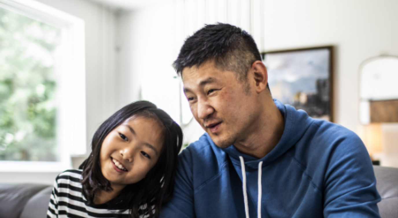 Father And Daughter Playing Video Games At Home